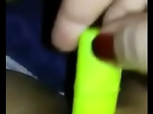 Girl masturbates with little green toy